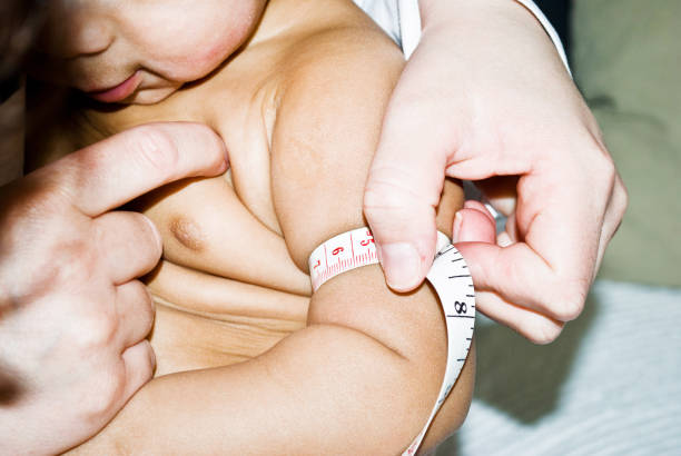 Toddler Physical Exam With With Measuring Tape stock photo