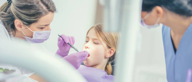 istock Dental hygienist at work 1026093586