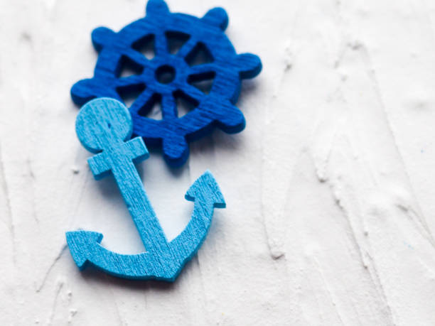 istock Background with decorative anchors and wheels on a white painted background. Place for text. Top view with copy space 1026097008