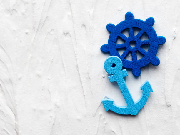 istock Background with decorative anchors and wheels on a white painted background. Place for text. Top view with copy space 1026097036