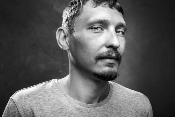 istock Portrait of a handsome young man, black and white image, close-up front view 1026108522