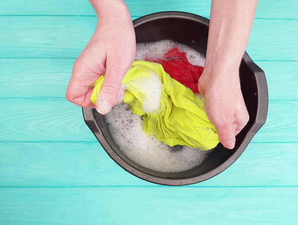 istock hands wash in a basin on a blue wooden background 1026125994