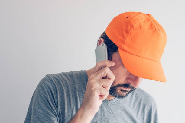 istock Man with baseball cap talking on smartphone 1026132240