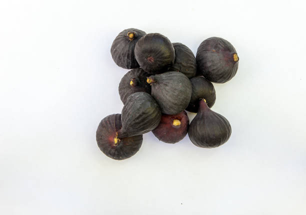 Fresh ripe sweet figs on white paper with copy space. stock photo