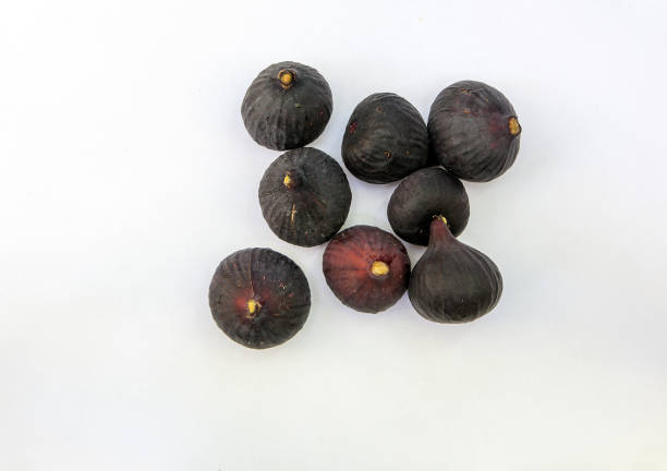 istock Fresh ripe sweet figs on white paper with copy space. 1026132426