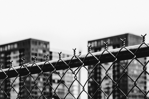 City buildings seen through fence.
Milwaukee, Wisconsin, USA