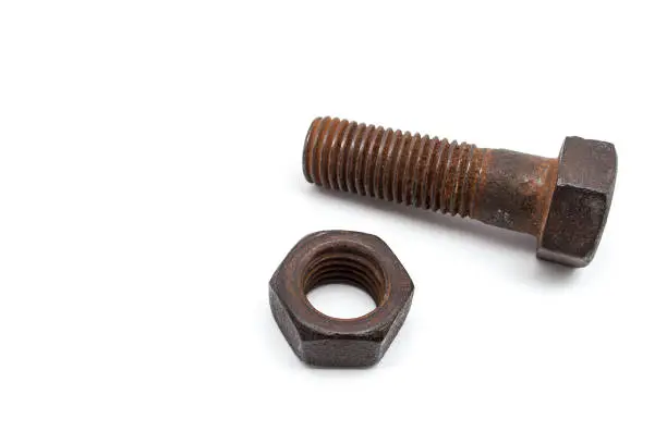 Photo of Rusty bolt and nut isolated on white background.