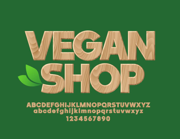 ilustraciones, imágenes clip art, dibujos animados e iconos de stock de vector emblema con tienda vegana de texto con el alfabeto - text wood alphabet nature