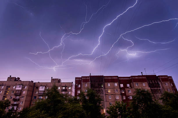 Thunderstorm in the night sky on residential buildings.