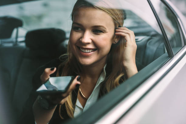istock Businesswoman making phone call in cab 1026164732