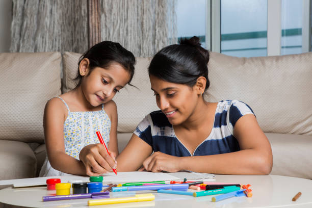 istock Mother and daughter together paint - Stock image 1026164752