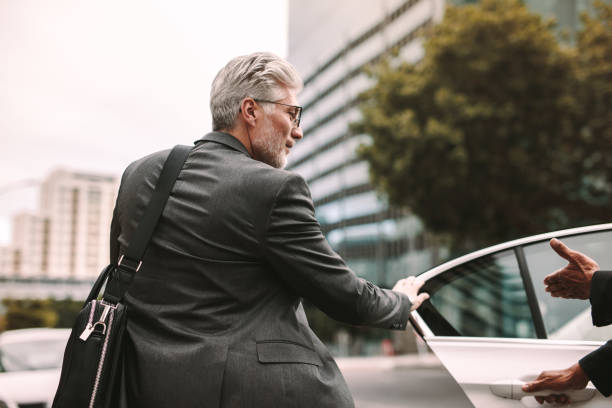 istock Mature businessman getting into a cab 1026164970