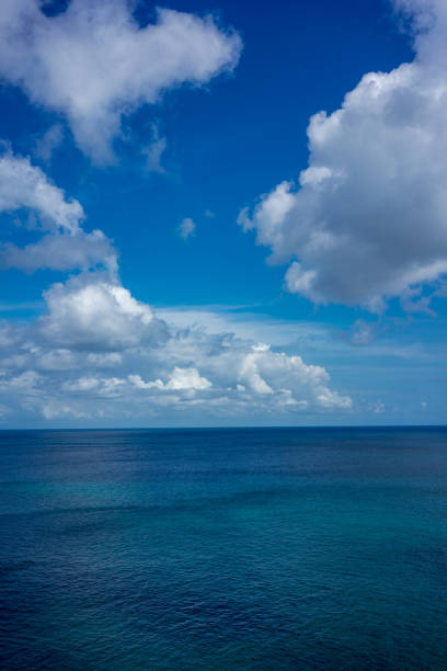 istock ocean water with blue sky and clouds, full frame 1026178402