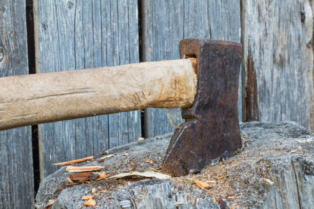 istock Axe in wood log on wooden background 1026187124