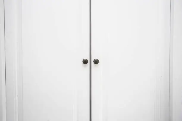 Photo of White wooden Closet doors close up background texture