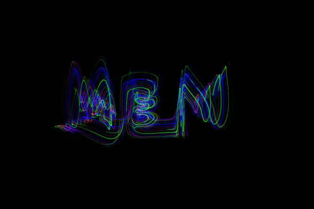 The word ‘MEN’ painted in the air in motion trails, captured on a long exposure. This text light painting on a black background consists of vibrant neon colours which are abstract, modern, stylish and unique. Look for WOMEN v2, for the matching pair.