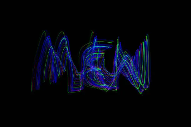 The word ‘MEN’ painted in the air in motion trails, captured on a long exposure. This text light painting on a black background consists of vibrant neon colours which are abstract, modern, stylish and unique. Look for WOMEN v1, for the matching pair.