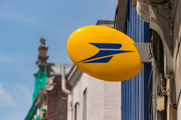 Logo of La Poste, French national postal service Lille, France - 15 June 2018: Logo of La Poste, French national postal service on Rue Nationale. post office stock pictures, royalty-free photos & images