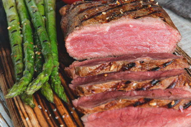 istock Grilled beef steak slicing medium rare , asparagus, tomato 1026199134