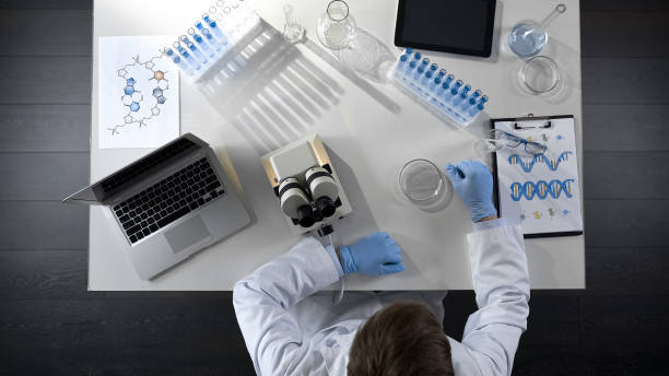 istock Chemistry student doing scientific experiments, conducting lab research, topview 1026202588