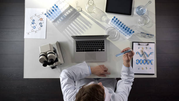 istock Biology student checking liquid in test tube, conducting research, top view 1026204982