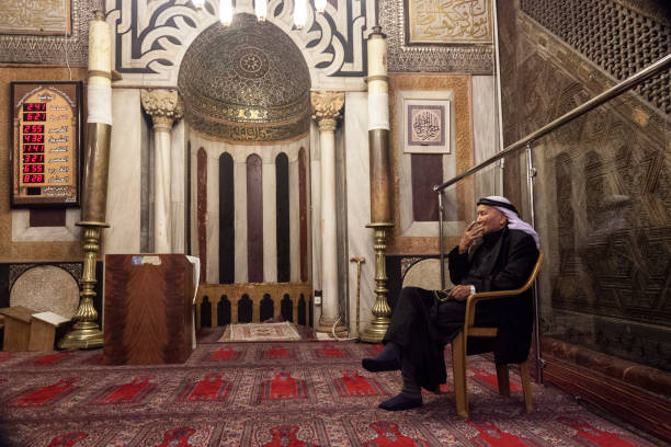 Abraham mosque in Hebron Hebron, Palestine, June 21, 2014: A Palestinian elderly man sits on a chair in the main hall in historic Abraham mosque in Hebron. father abraham stock pictures, royalty-free photos & images