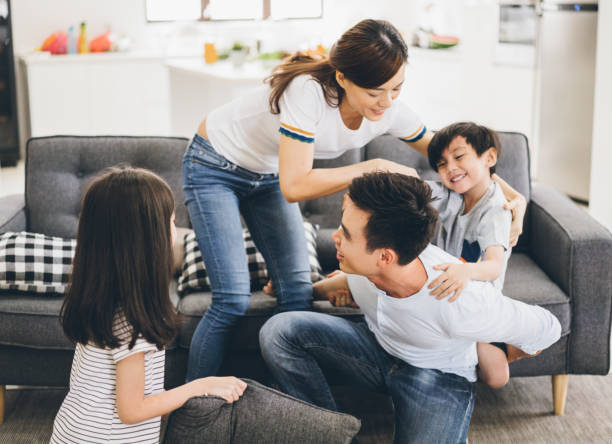 istock Parents playing with children at home 1026205422