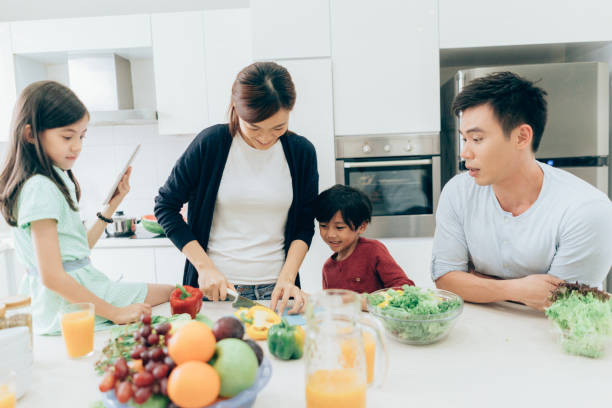 istock Cheerful family preparing lunch together 1026205426