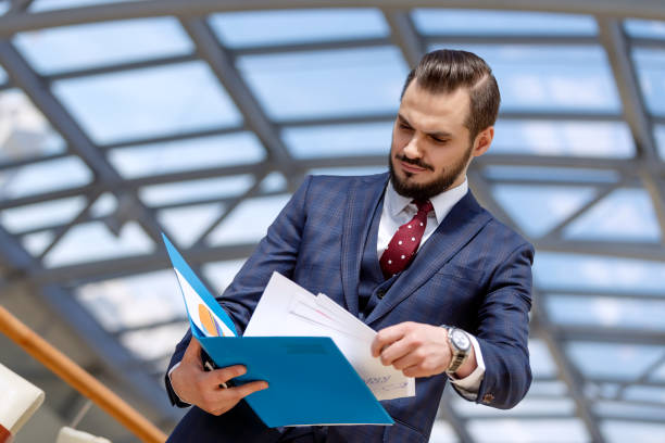 istock Businessman holding binder 1026215154