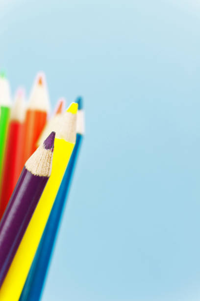 istock coloured pencils against blue backgroud 1026218614
