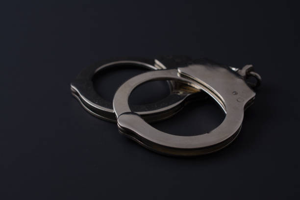 istock Metal handcuffs on black background 1026218698