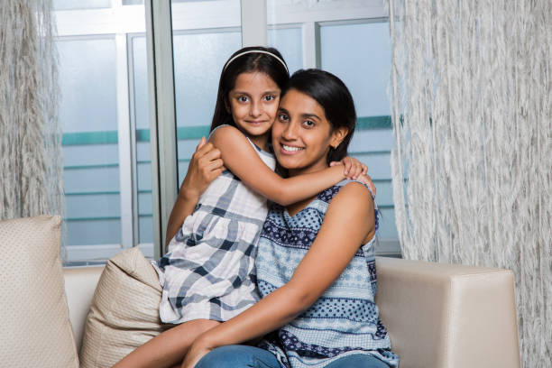 istock Attractive caring mother hugging her daughter - Stock image 1026224446