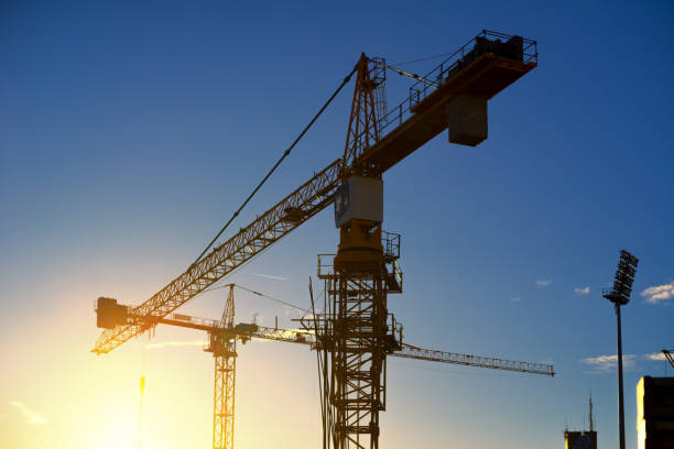 istock Silhouettes of cranes on the construction site 1026227060