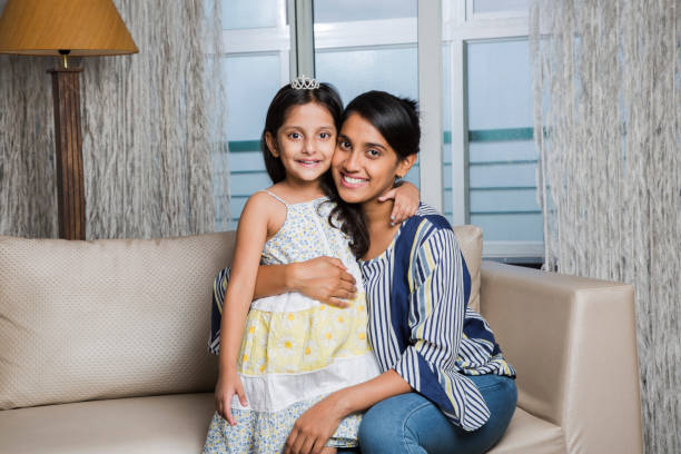 istock Attractive caring mother hugging her daughter - Stock image 1026227226