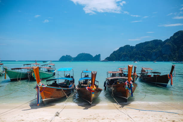 istock Longtail boats on the sandy beach of the Koh Phi Phi, Thailand 1026234170