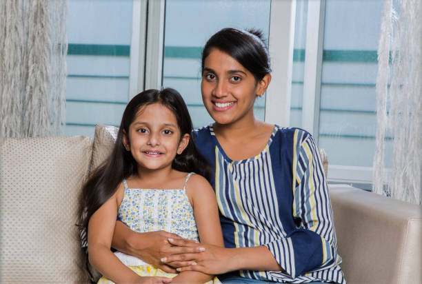 istock Attractive caring mother hugging her daughter - Stock image 1026234200
