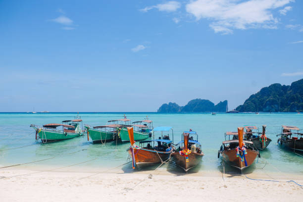 istock Longtail boats on the sandy beach of the Koh Phi Phi, Thailand 1026236280