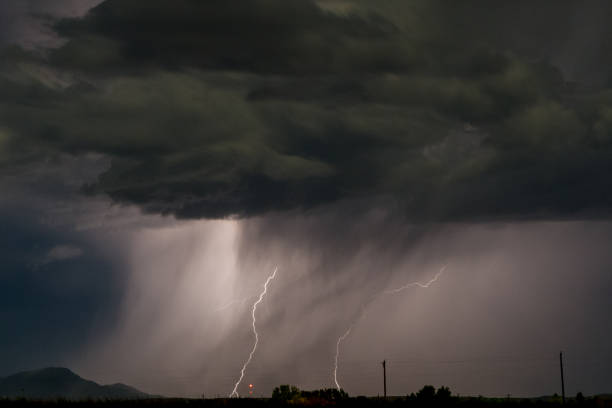 Image of lightning striking the ground stock photo