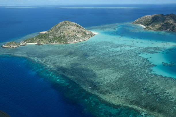Aerial view around Lizard Island, Great Barrier Reef Aerial view of the lagoon, coral reefs and small islands adjacent to Lizard Island, Great Barrier Reef, Queensland, Australia. lizard island stock pictures, royalty-free photos & images