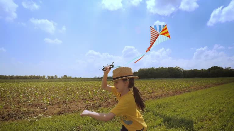 Beautiful Little Girl Flying A Kite. Happy Memories Of Her Young Days