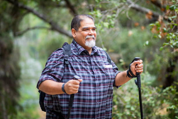 Senior Mexican Man Hiking A senior mexican man hiking on a beautiful day outdoors. fat mexican man pictures stock pictures, royalty-free photos & images