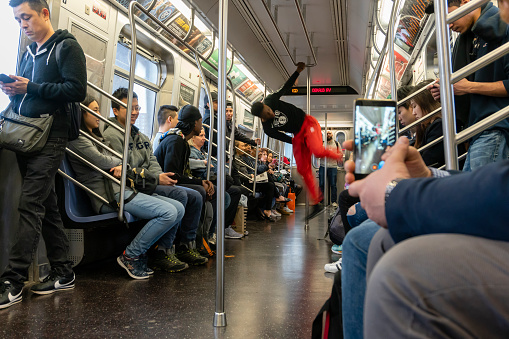 New York, New York, USA, April 7, 2023 - Tourists and locals traveling on a subway train in New York City.