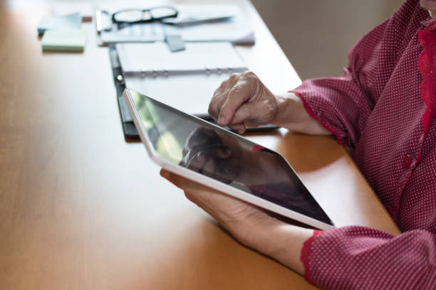 istock woman working with digital tablet at office. hand pointing on touchpad 1026273840