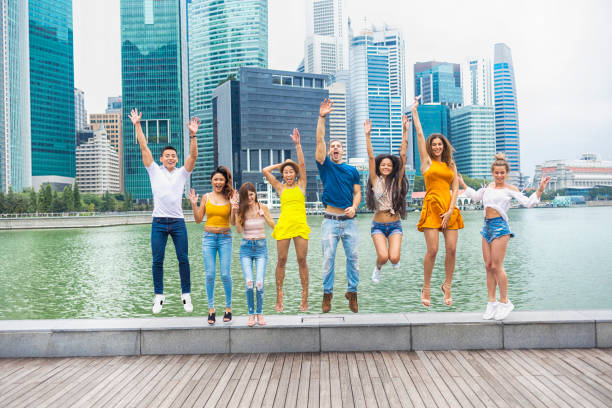 istock Friends jumping on street, arms raised 1026273976
