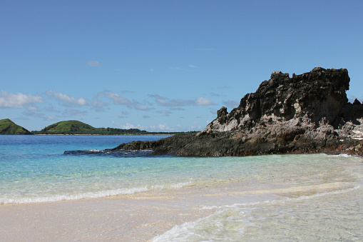 Calm, transparent sea on a beautiful blue sky day on Monuriki island, in Fiji, where the movie 