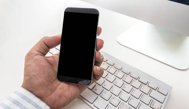 istock Male hand holding smart phone on white background 1026285312