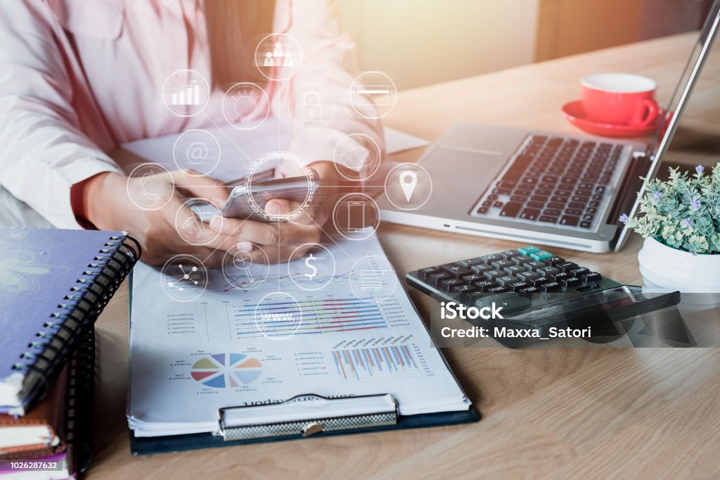 Business woman hand using smartphone with digital marketing via multi-channel communication network on mobile application technology. Automated Stock Photo
