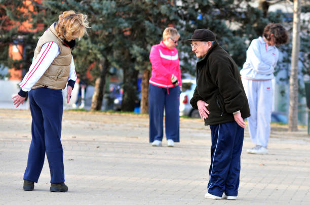 MADRID - MARCH 01 2010: Spanish  senior adults exercising in a park in Madrid, Spain.According to OECD data Spain has the second-highest life expectancy in the world after Japan, Male 80 female 85.