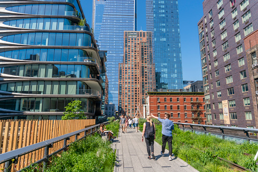 New York, USA - May 25, 2018: People walking along The High Line in New York. It is a elevated greenway on the west side of Manhattan in New York City.