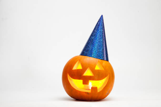 istock Halloween pumpkin head jack lantern with burning candles with festive hubcap isolated on white background 1026308552